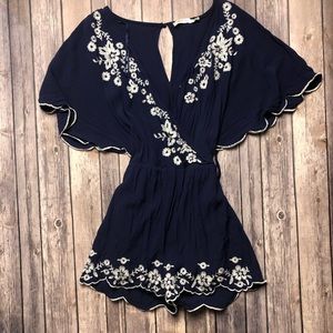 Beautiful blue boutique romper with floral accents